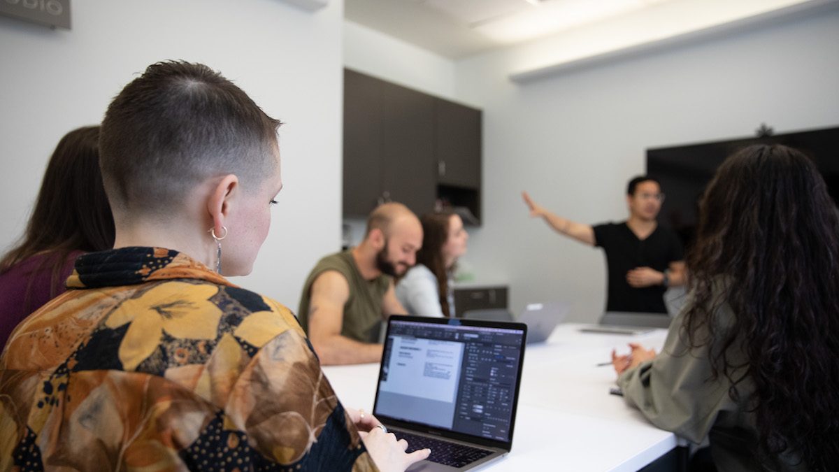 Group of people in a office talking and working together.