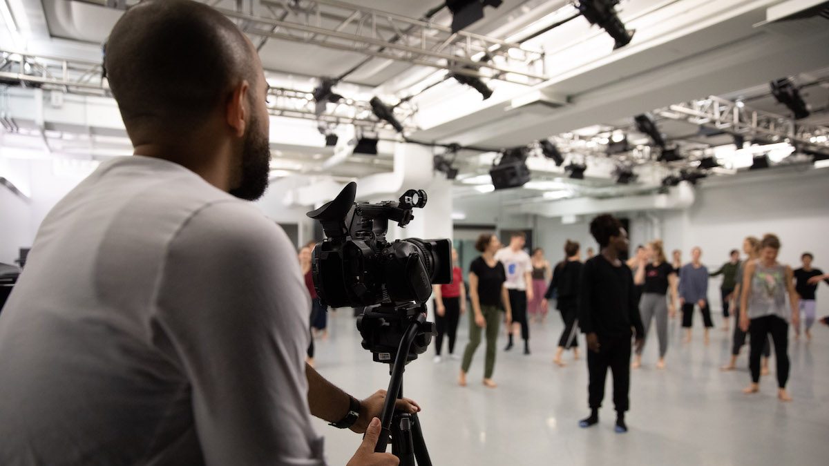 Man filming a dance class.