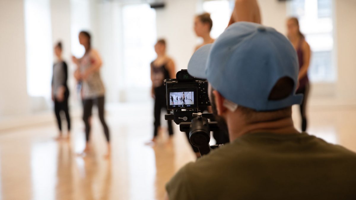 Group Study DMI Workshop - A view over the shoulder of a man filming a dance class