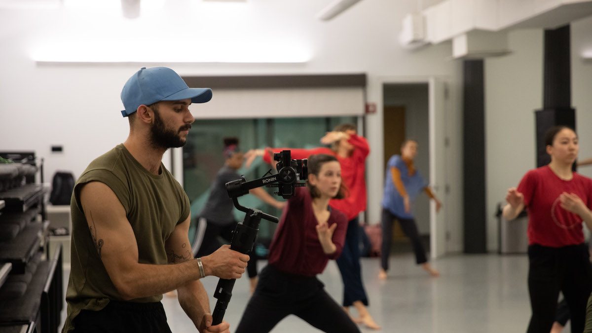 Man filming a dance class.