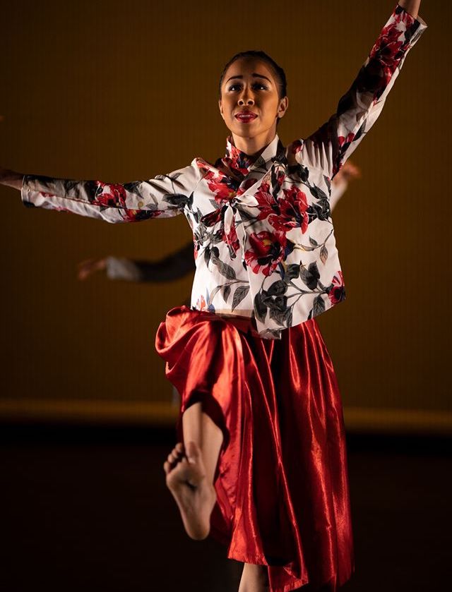 Woman in red dancing on stage.