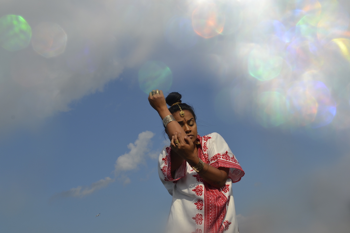 Woman of color dancing in the sky.