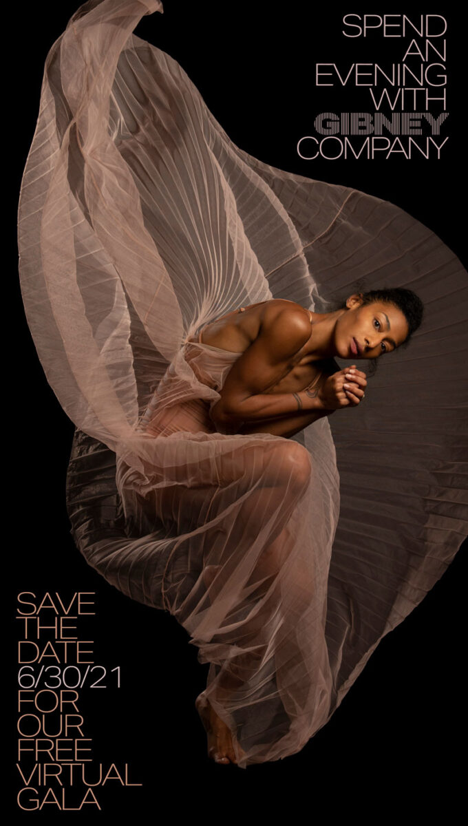 Gibney Company Dancer Rena Butler wears a flowing beige skirt, crouching over and looking directly at the camera.