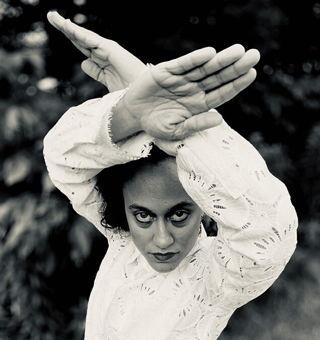 Ra Ruiz Leon posing with arms and hands in a black and white photo at Jacobs Pillow in MA, summer 2019.