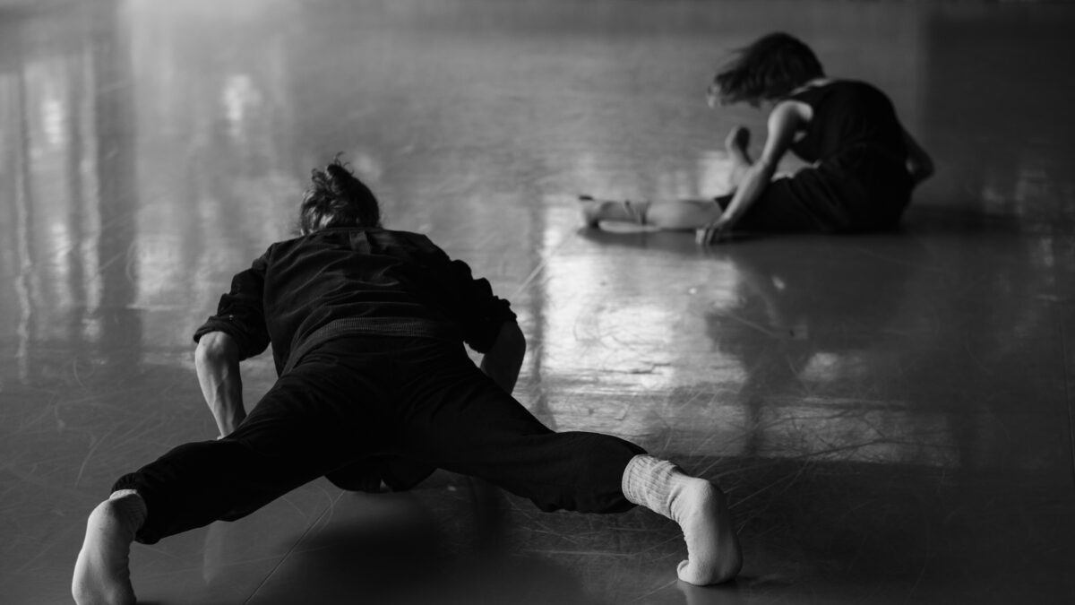 Black and white photo of a dancer on moving into the floor.